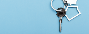 A house key on a pale blue background