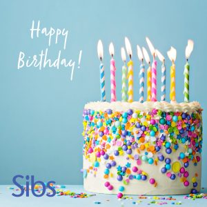 Colourful birthday cake on light blue background