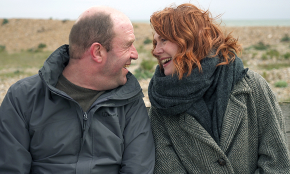 Ruby & her brother directly face each other, grinning